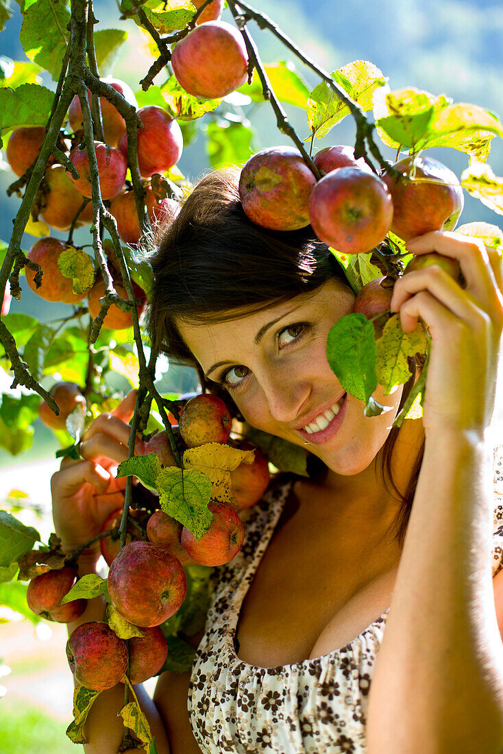 Young woman under an apple tree, Styria, Austria