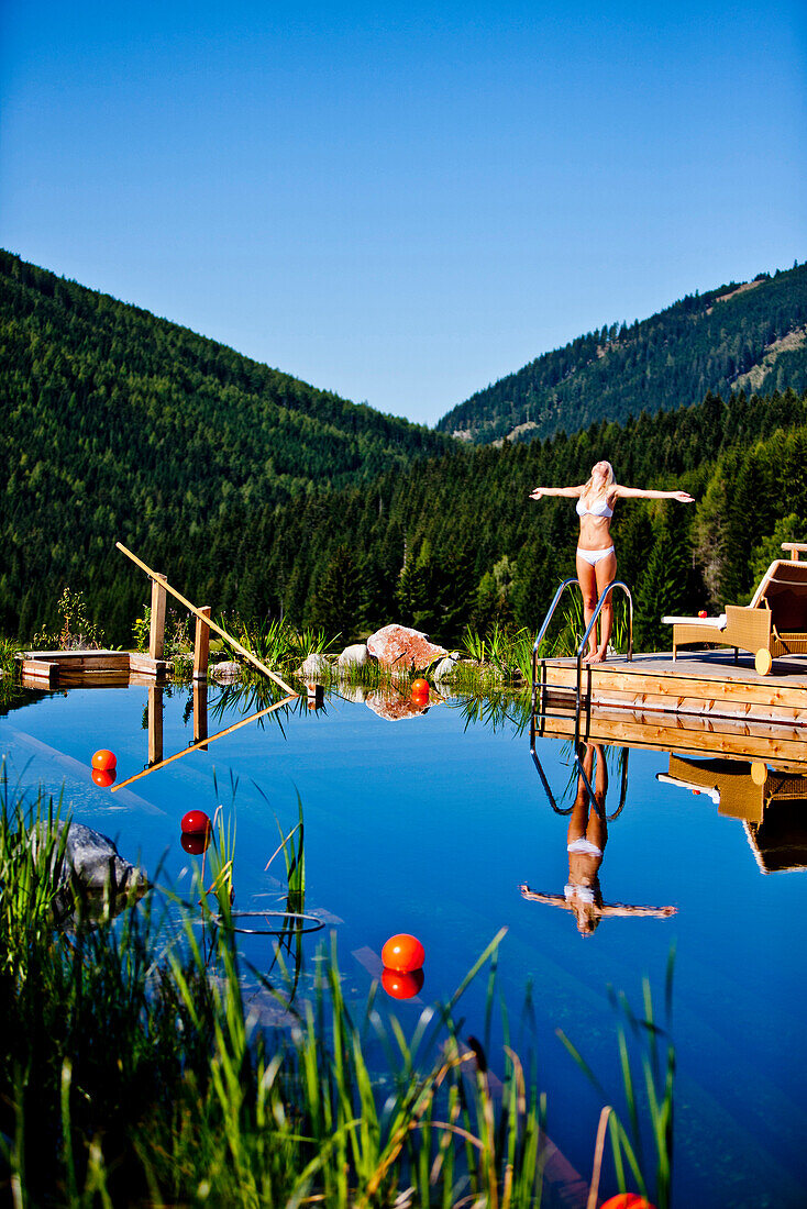 Young woman at a swimming pool of a hotel, Fladnitz an der Teichalm, Styria, Austria