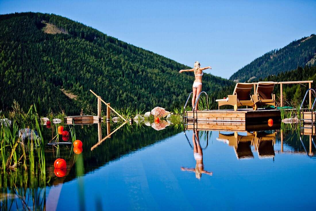 Young woman at a swimming pool of a hotel, Fladnitz an der Teichalm, Styria, Austria