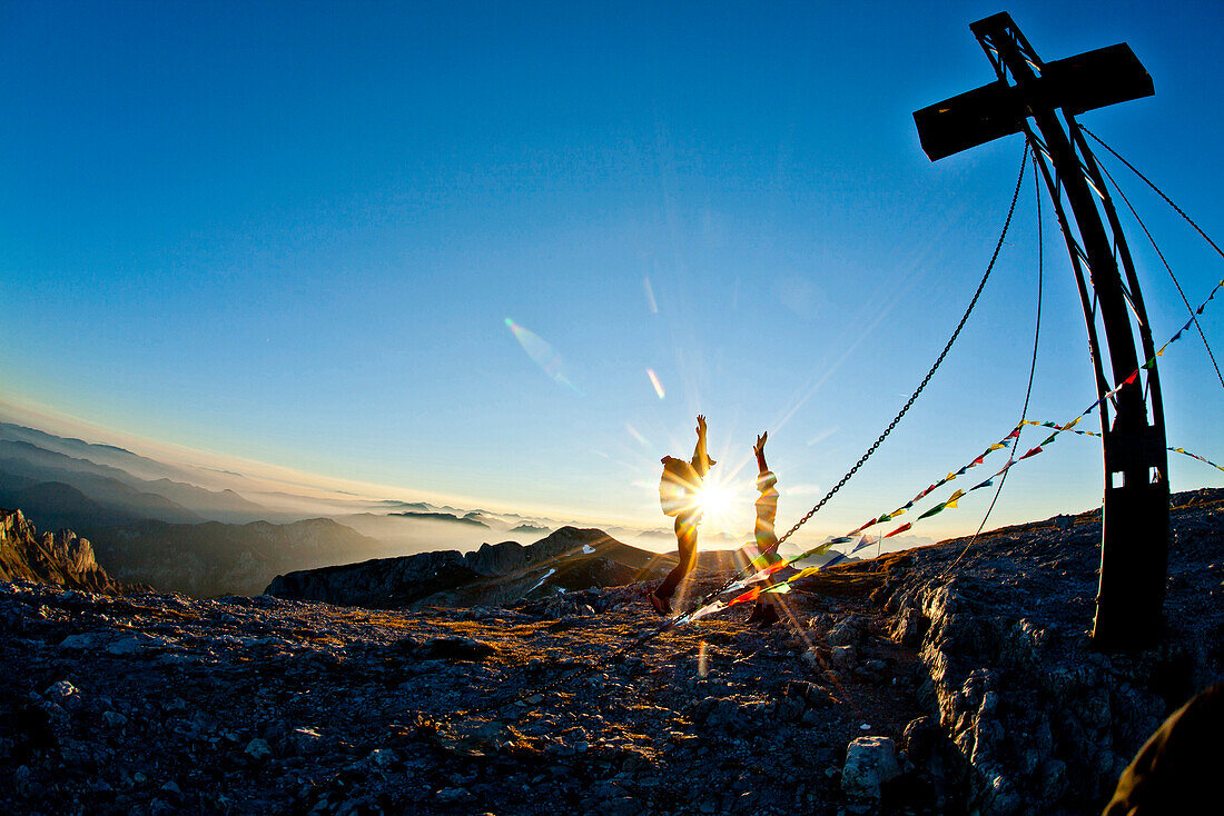 Hikers on summit of mount Hochschwab in sunset, Styria, Austria