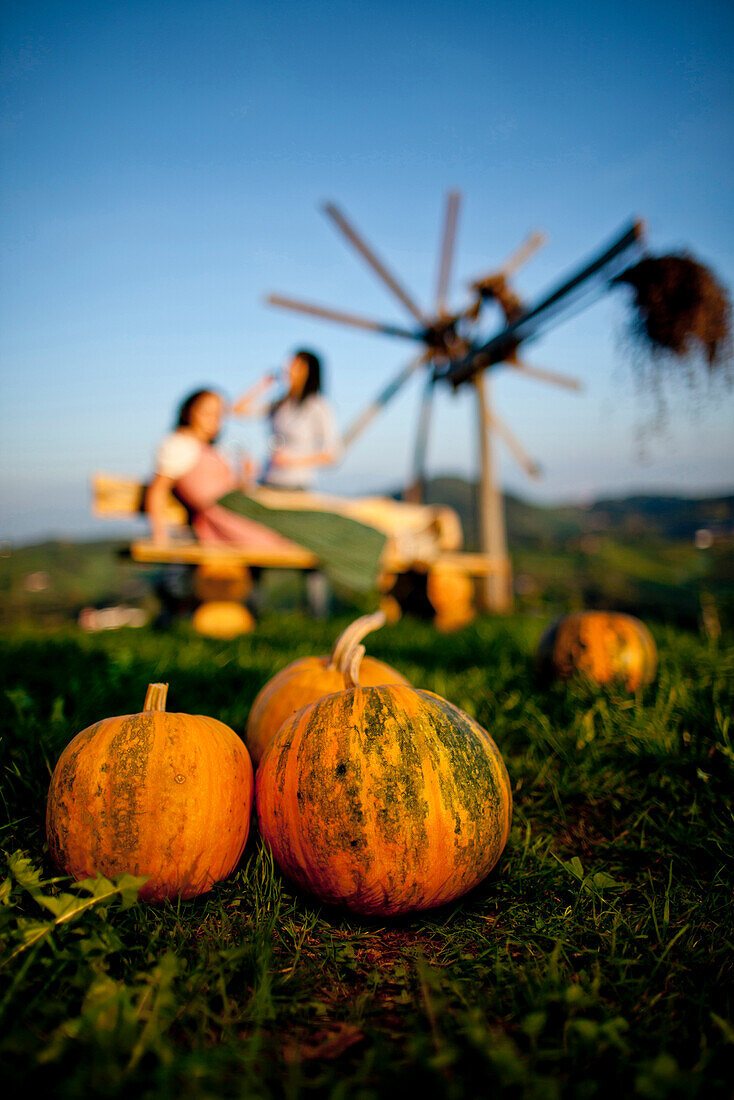 Two young women, pumpkins in foreground, Styria, Austria