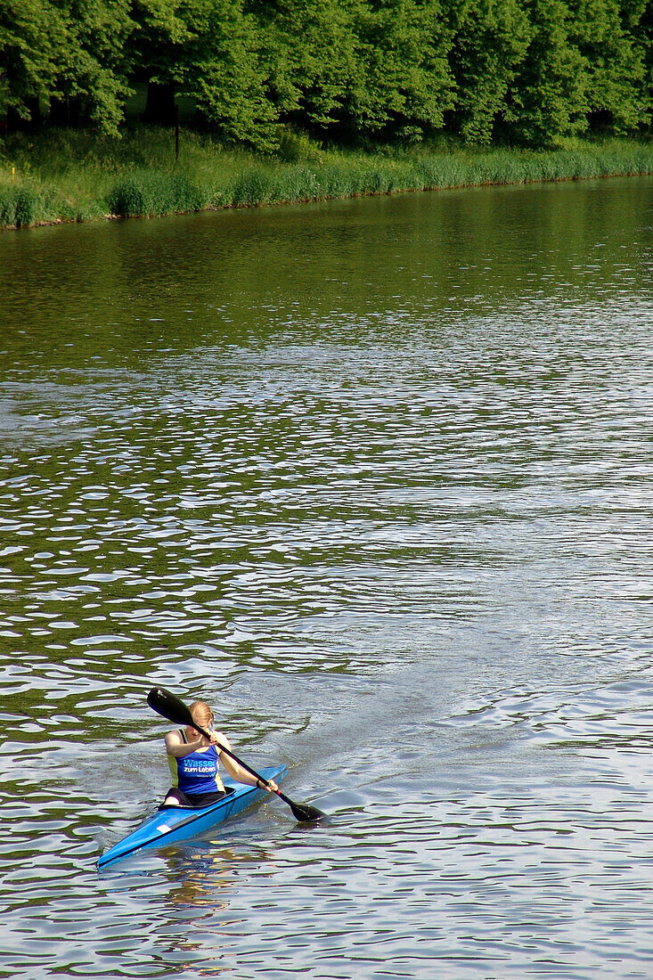 Canoeist in  Elster Floodchannel, Clara Zetkin Parc, Saxony, Germany