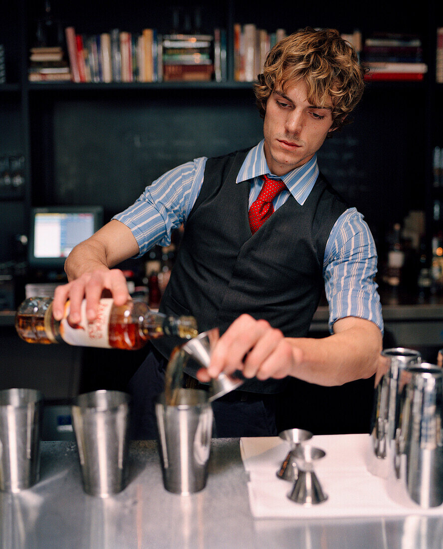 USA, California, Los Angeles, bartender making drink at Comme Ca Restaurant.
