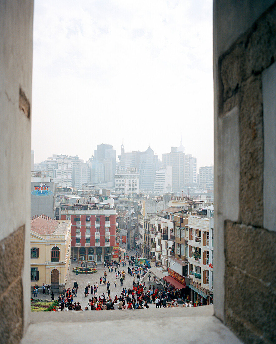 CHINA, Macau, Cityscape and crowd through ruins of St. Paul, 17th century, Cathedral, UNESCO world heritage site, catholic