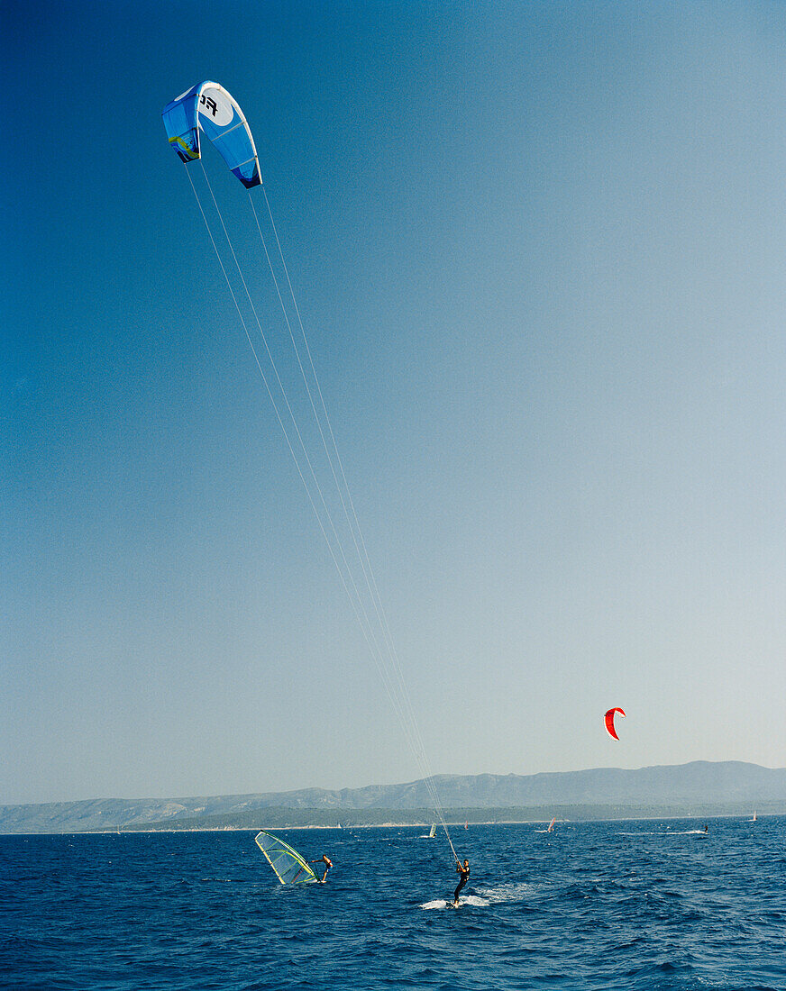 CROATIA, Bol, Brac, Dalmatian Coast, kite surfers along Zlatni Rat Beach.