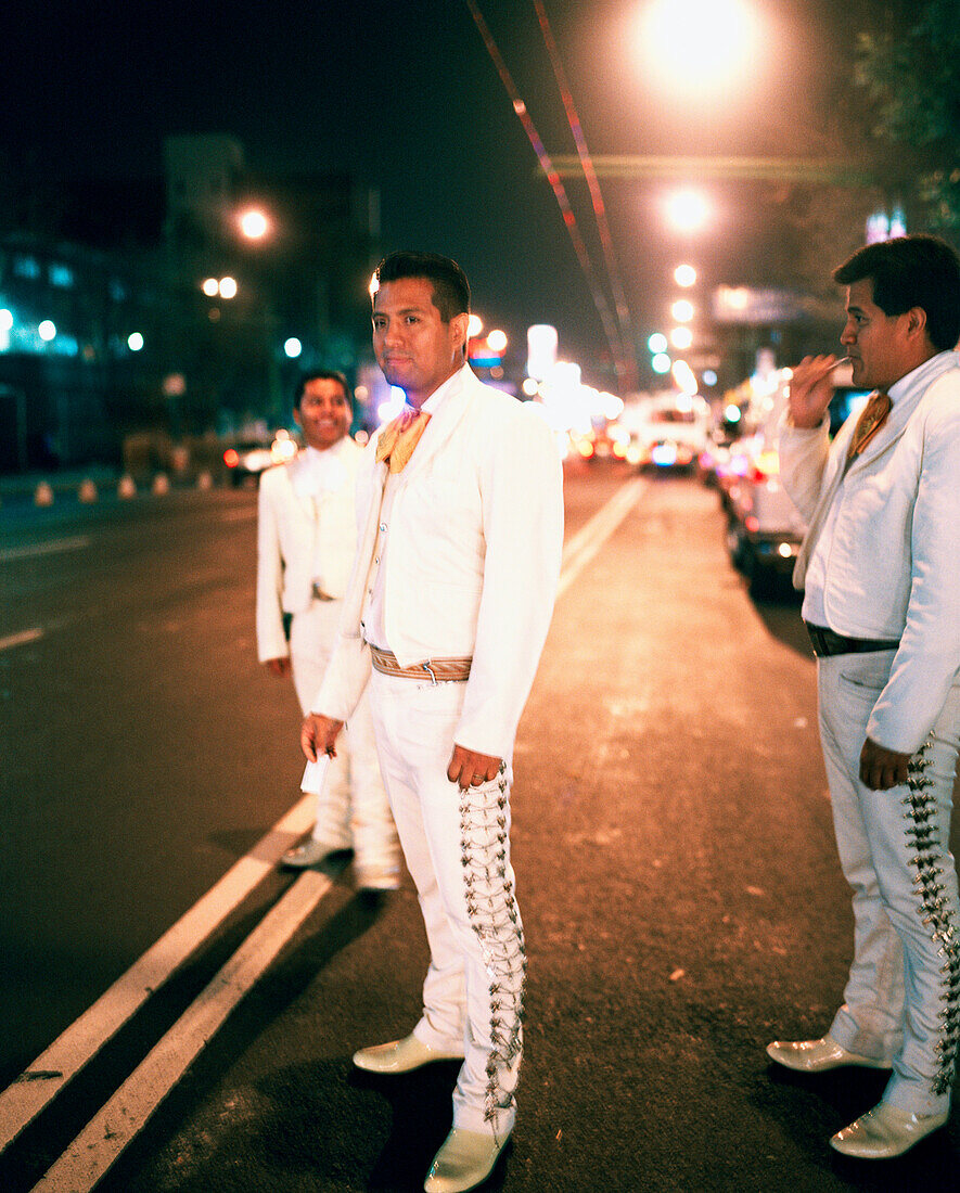 MEXICO, Mexico City, musician standing on illuminated street at night