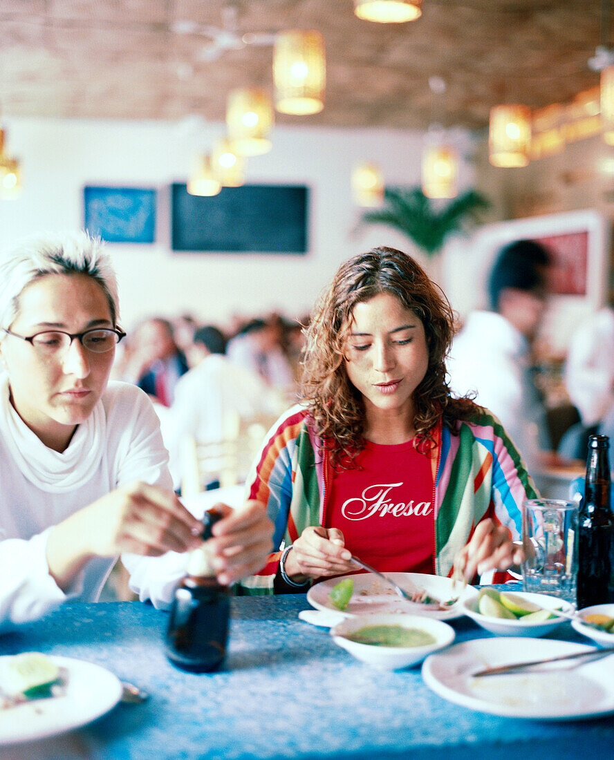 MEXICO, Mexico City, two young women eating at Contramar Restaurant