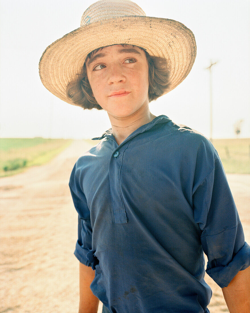 USA, Minessota, portrait of a young Amish boy with hat.