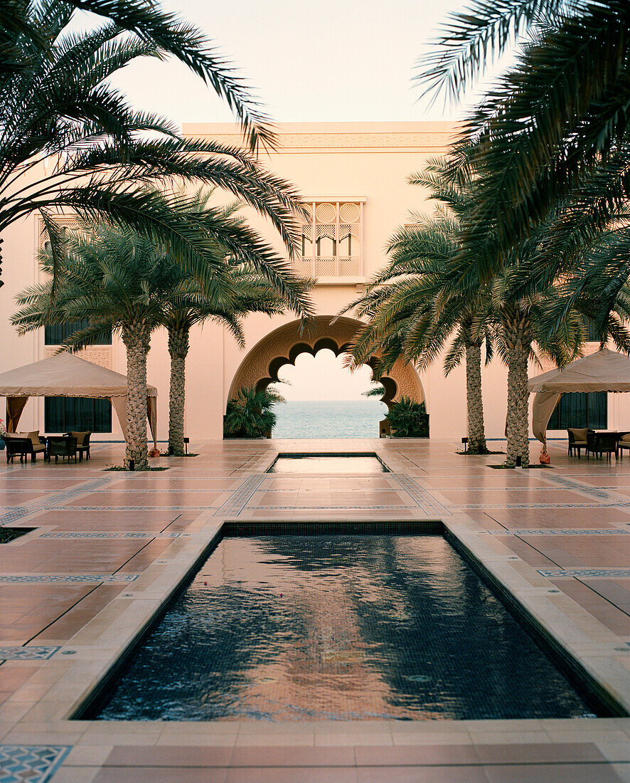 OMAN, Muscat, pool at Barr Al Jissah Resort and Spa with sea in the background