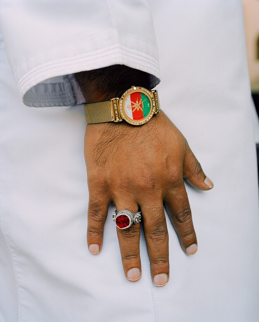 OMAN, man wearing wristwatch and finger ring, flag designed on watch dial
