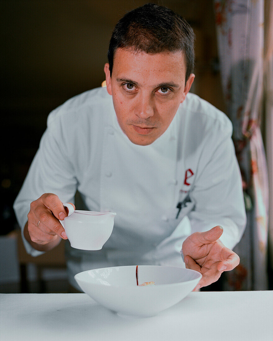 SPAIN, Ezcaray, chef Francis Paniego plating a dish at his restaurant, El Portal De Echaurren.
