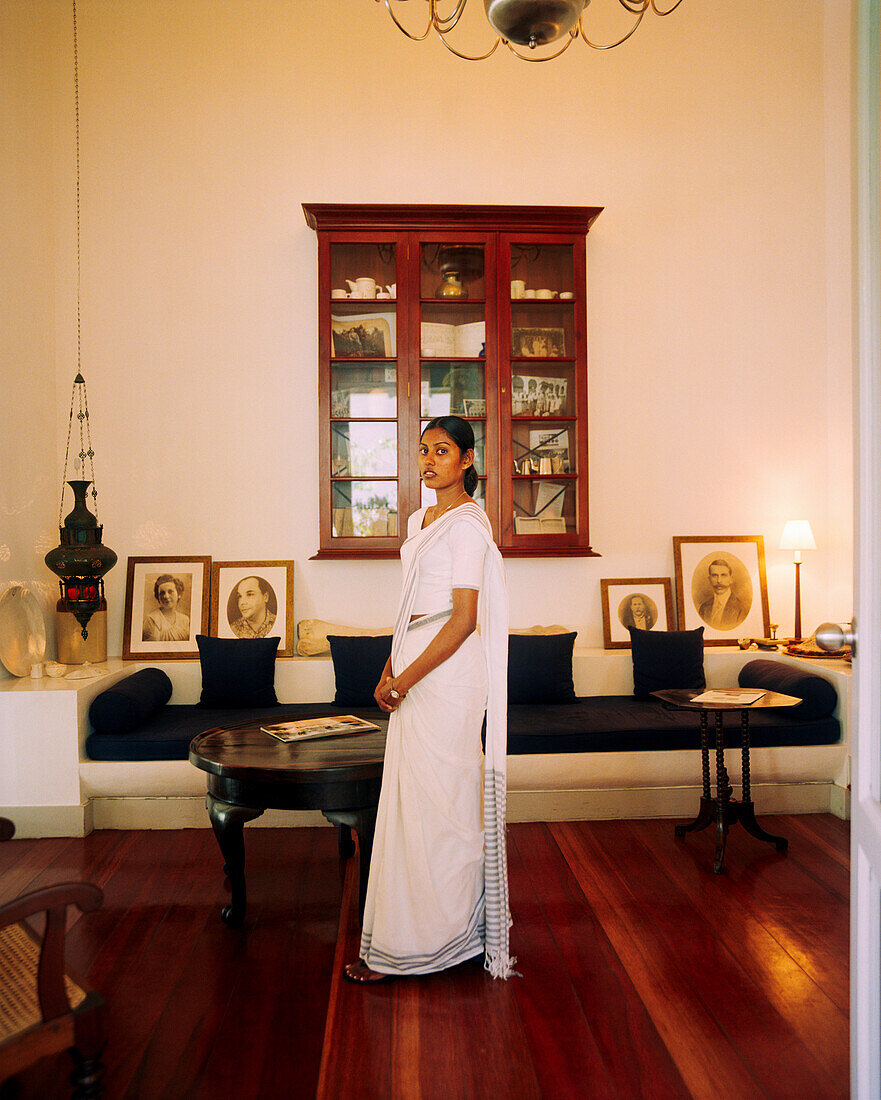 SRI LANKA, Asia, Galle, portrait of a woman in sari standing in library of the Amangalla Hotel in Galle.