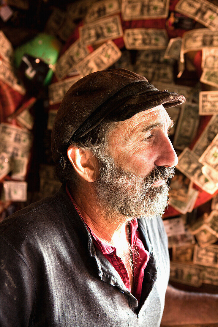 ALASKA, Homer, portrait of a fisherman Albert Arakelaine at the Salty Dawg Saloon after a long day of fishing, Land's End, the Homer Spit