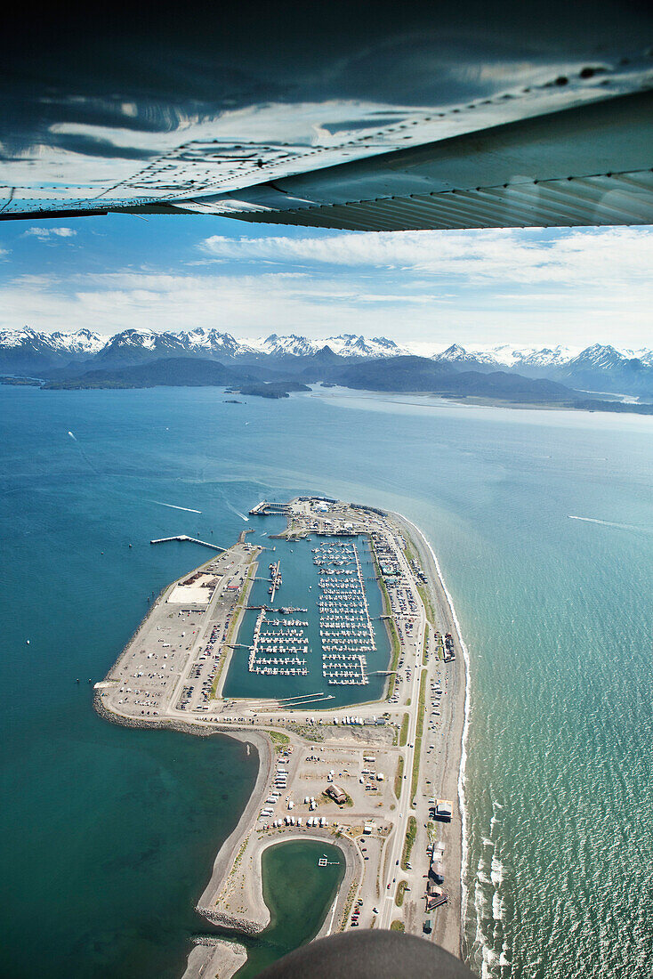 ALASKA, Homer, an aerial view of the Homer Spit and marina, Land's End, Kachemak Bay with the Kenai mountains in the distance