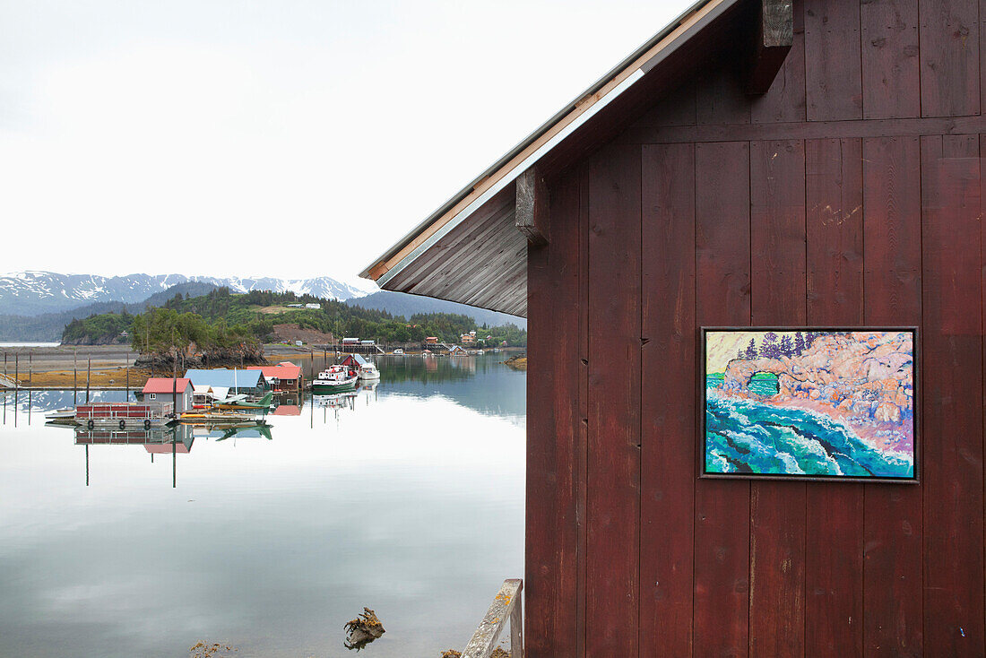 ALASKA, Homer, a painting hangs on the exterior wall of an art gallery, Halibu Cove