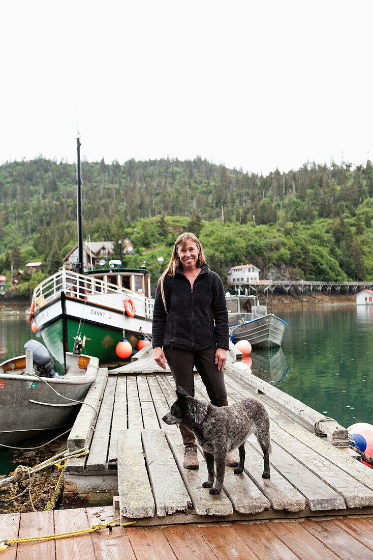 ALASKA, Homer, Marian Beck, the owner of the Saltry restaurant with her dog Pico, Halibut Cove