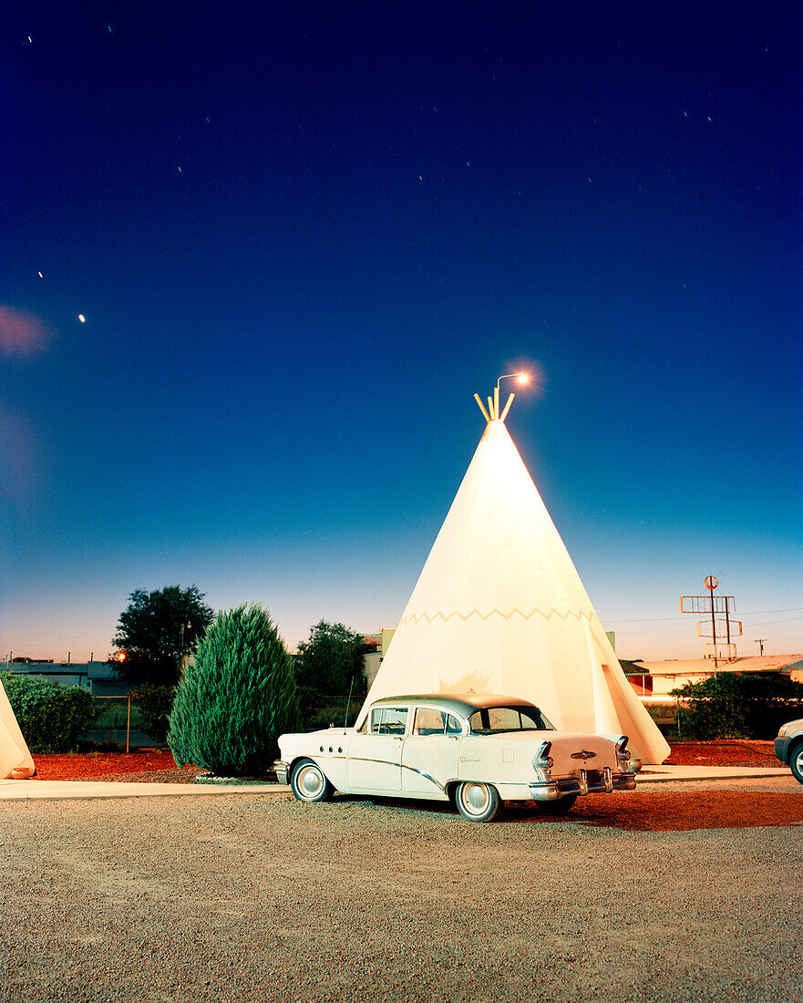 USA, Arizona, Holbrook, classic car parked by teepee, Wigwam Motel