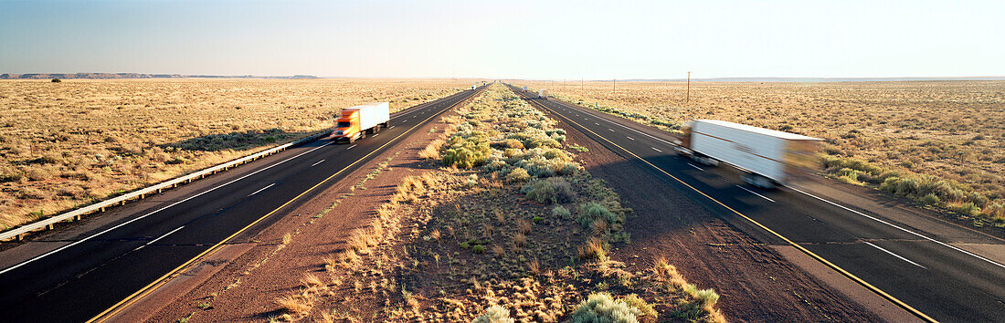 USA, Arizona, trucks driving on Route 66, Petrified Forest National Park, Painted Desert
