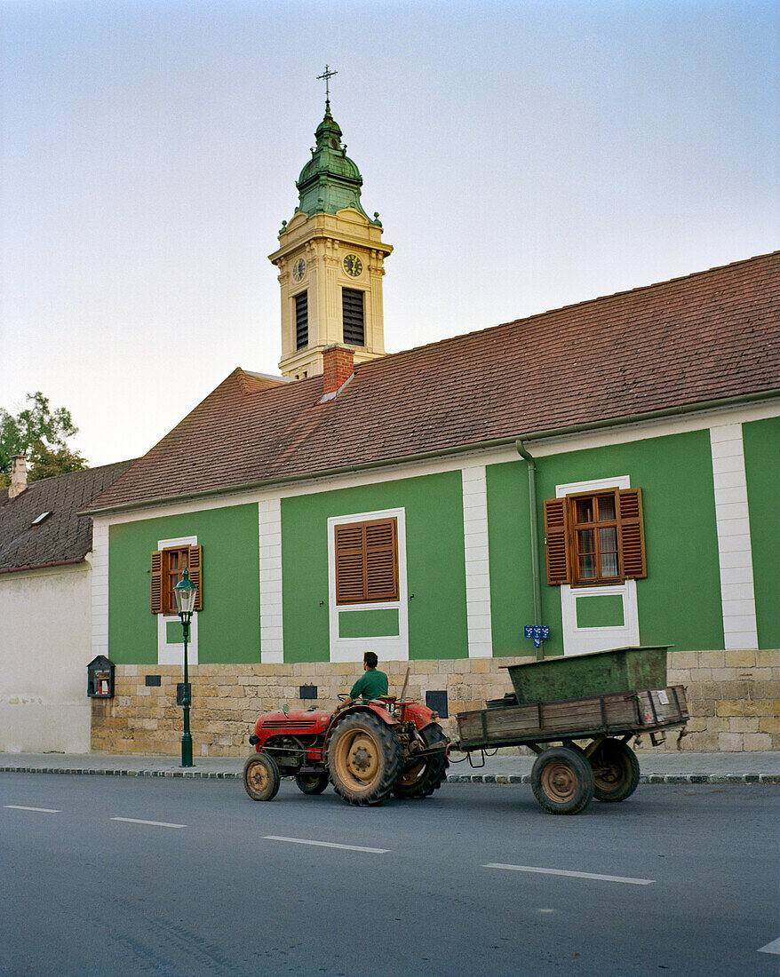 AUSTRIA, Rust, a man drives his tractor to the fields to harvest grapes in the morning, Burgenland