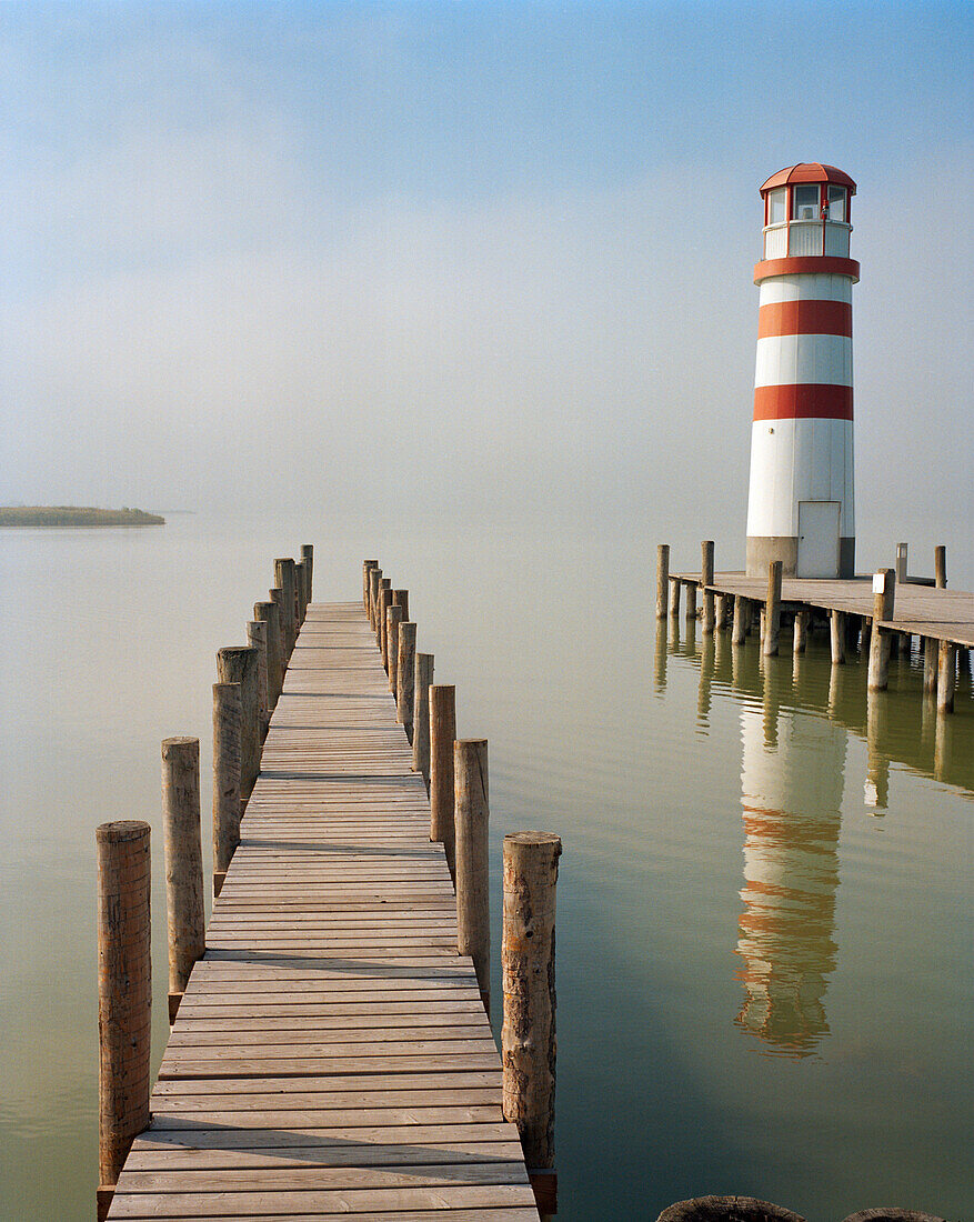 AUSTRIA, Podersdorf, a pier and a lighthouse in the fog, Lake Neusiedler See, Burgenland