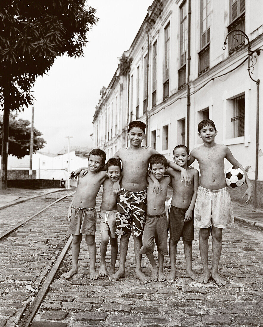 BRAZIL, Belem, South America, portrait of happy shirtless boys, one with soccer ball