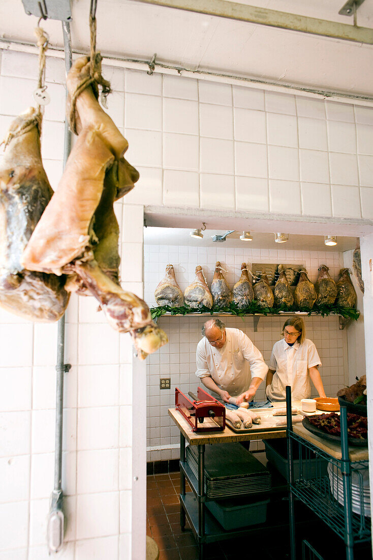 USA, California, chef with meat in kitchen, Eccolo Restaurant, Berkeley