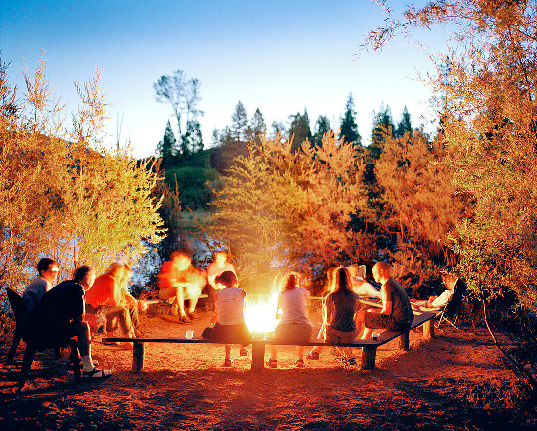 USA, CALIFORNIA, friends around campfire, South Fork of the American River