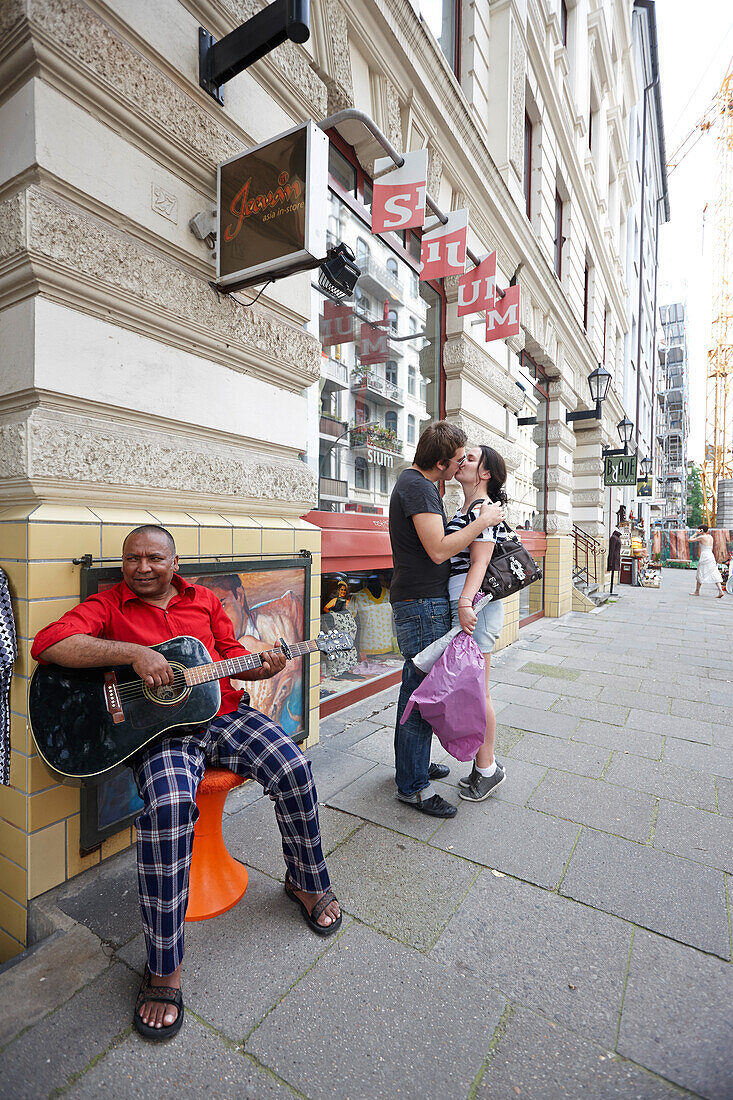 Jiwan playing the guitar, Nepalese owner of Jeevan boutique, Marktstrasse, Hamburg, Germany