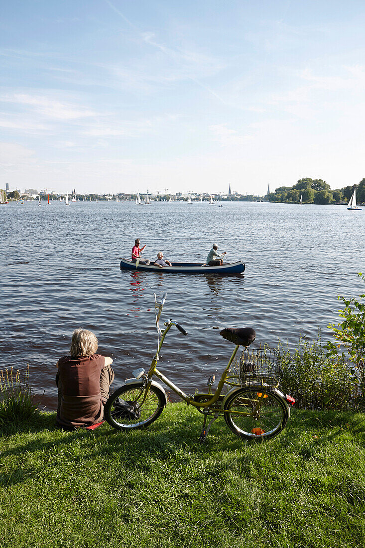 Radler am Ufer und Paddelboot auf der Außenalster, Blick vom Hotel Bellevue, Hamburg, Deutschland