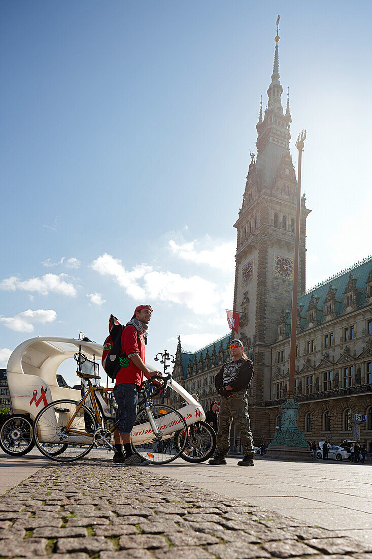 Trikshaw and bike courier on the town hall square, Hamburg, Germany