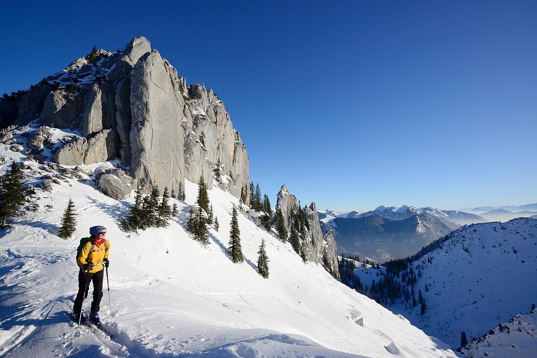 Female backcountry skier ascending to Risserkogel, Blankenstein in background, Bavarian Alps, Upper Bavaria, Bavaria, Germany