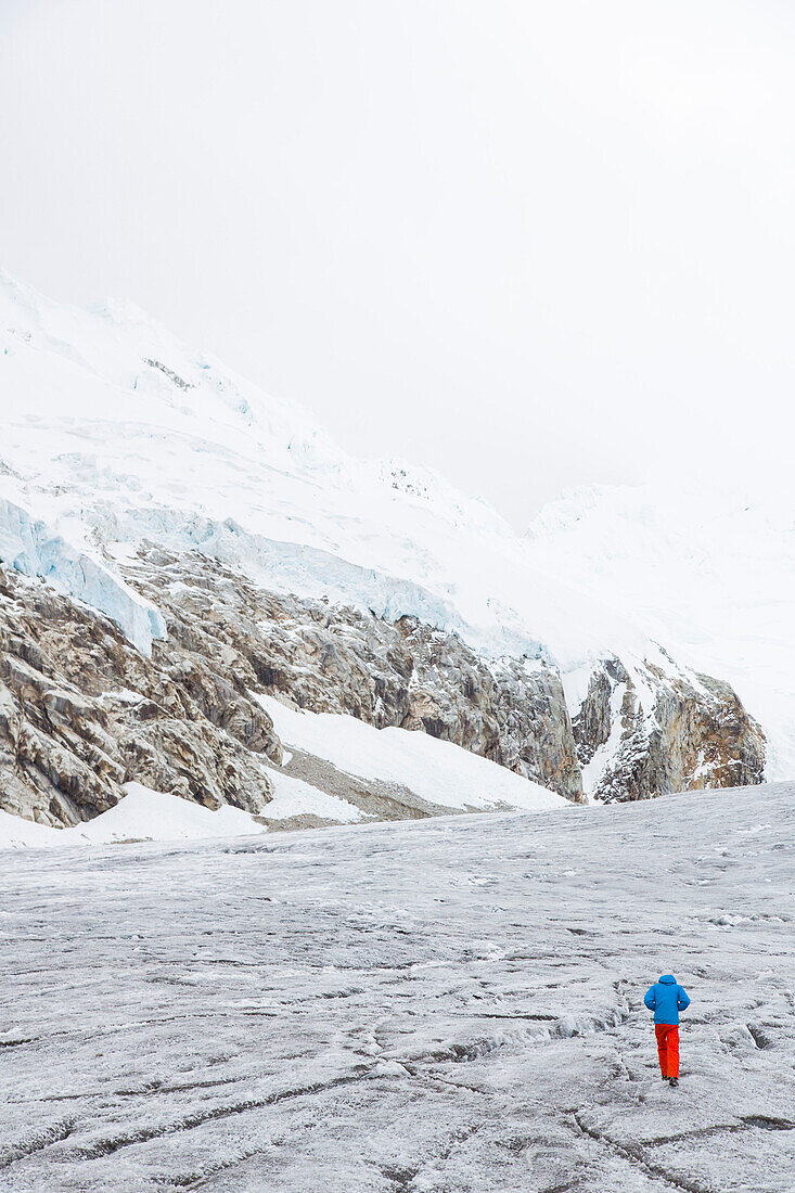 Man walking over a glacier, Artesonraju, Paron Valley, Caraz, Huaraz, Ancash, Cordillera Blanca, Peru