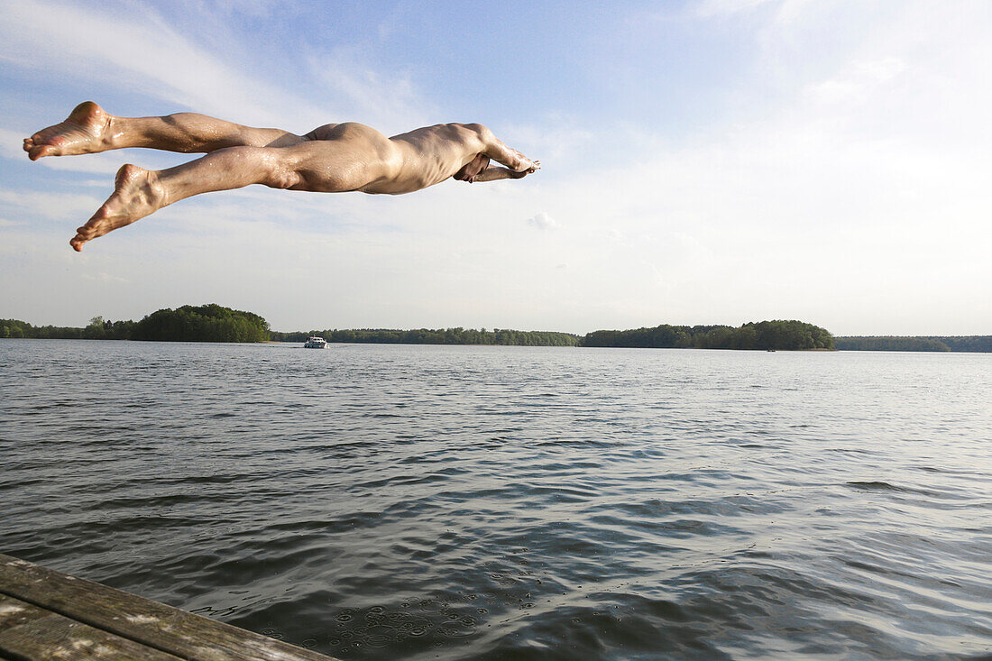 Naked man jumping into a lake, Lychen, Uckermark Lakes Nature Park, Uckermark, Brandenburg, Germany