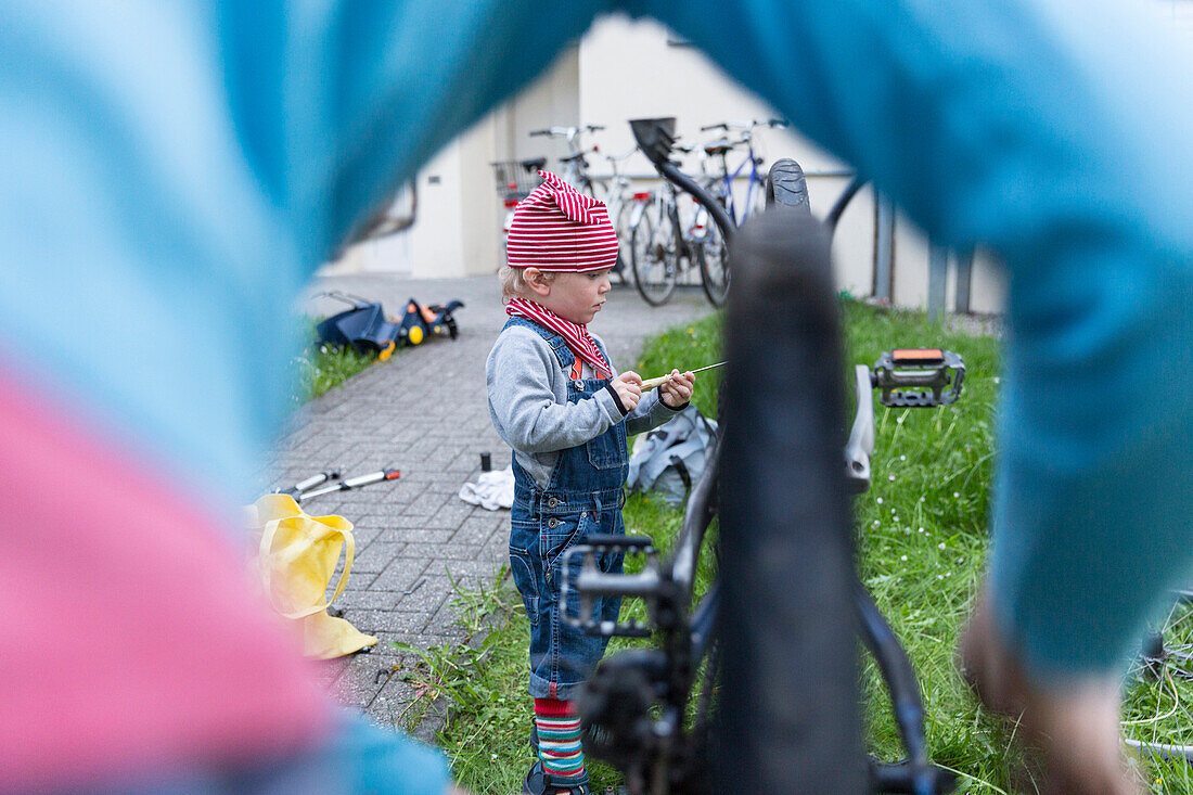 Father and son repairing a bicycle, Leipzig, Saxony, Germany