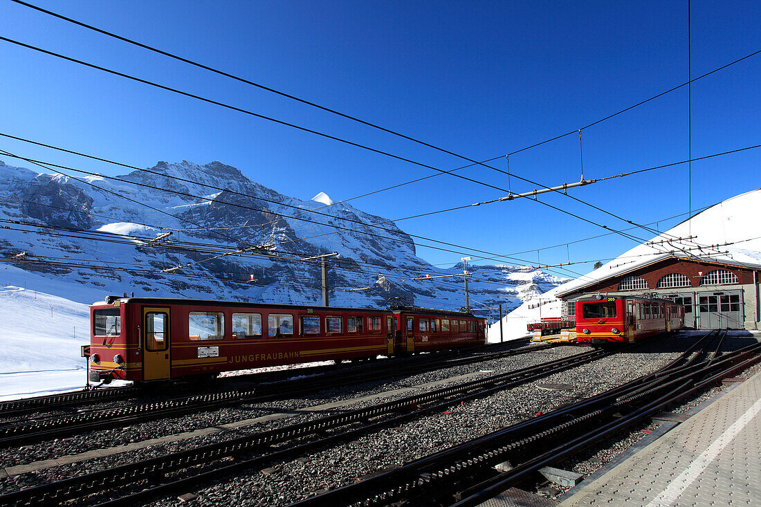 Jungfraubahn trains in the station at the ski resort of Kleine Scheidegg , Swiss Alps, Jungfrau - Aletsch, Bernese Oberland, Switzerland, Europe