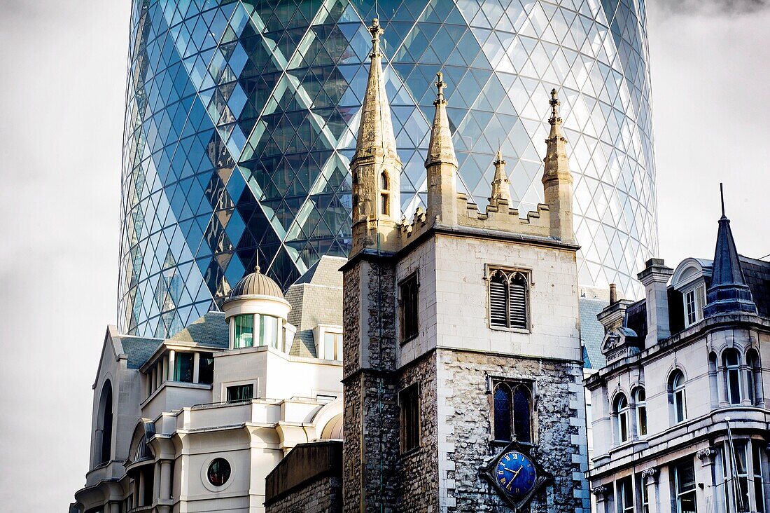 contrast of old and new architecture with Gherkin building designed by Foster and Partners on the background, London, England, UK