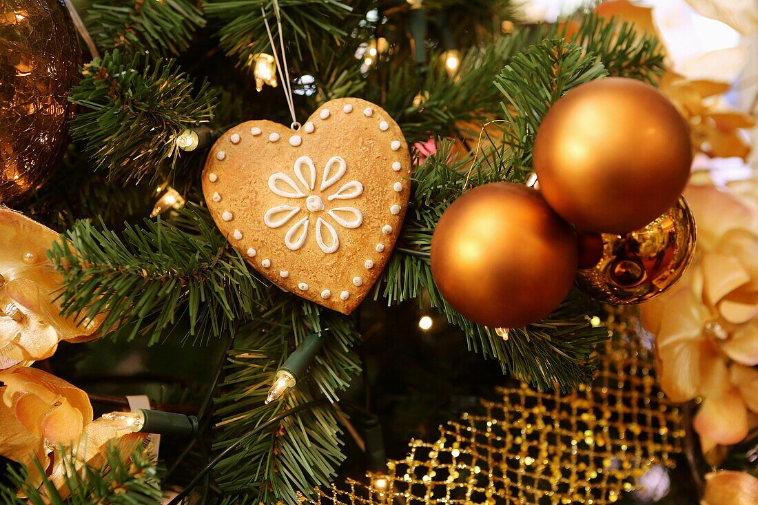 Christmas decoration  Golden baubles and gingerbread on tree