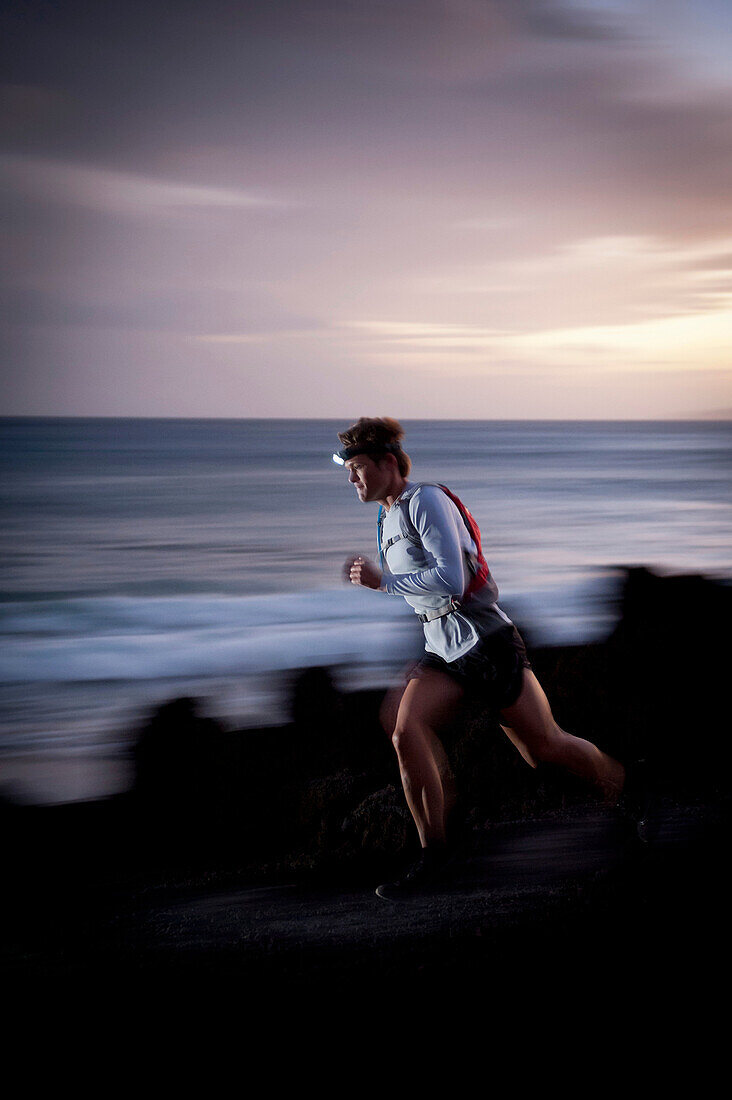 Blurred view of runner on rocky trail. Hoapili Trail