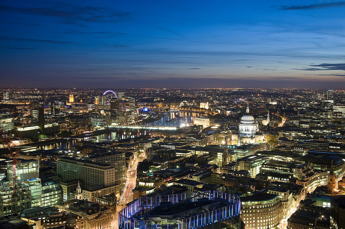 Aerial view of cityscape lit up at night