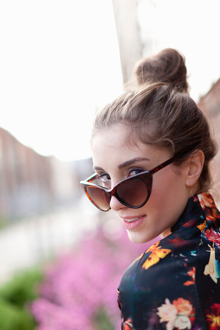 Woman peering over sunglasses