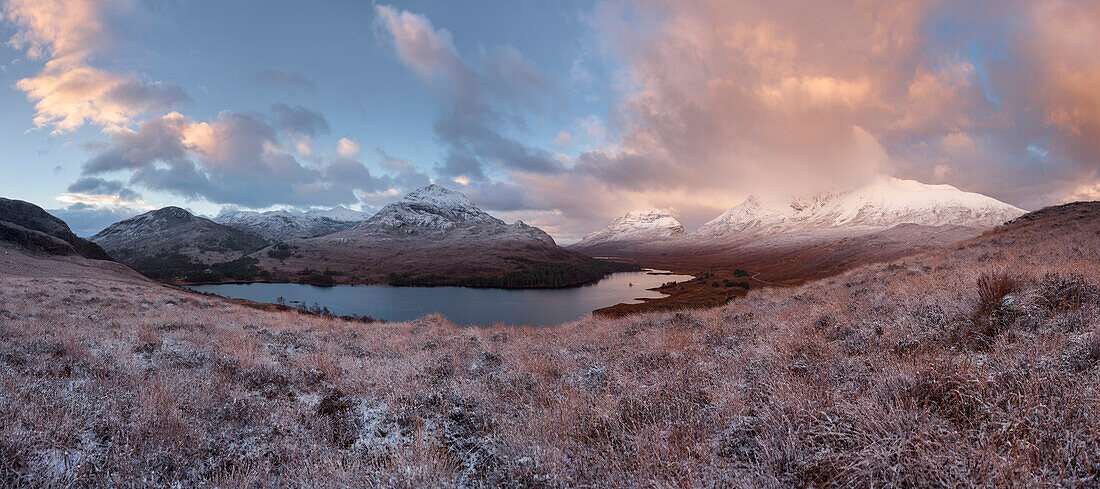 Vast panorama of the snow-covered North West Highlands overlooking the summits of Sgurr Dubh, Liathach and Beinn Eighe (from left) over the Loch Clair in Winter at sunrise, Torridon, Scotland, United Kingdom