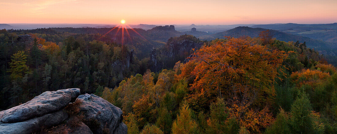 Sunset view from the Carolafelsen to the peaks of Schrammsteine, Falkenstein and Lilienstein in Autumn, Saxon Switzerland national park, Saxony, Germany