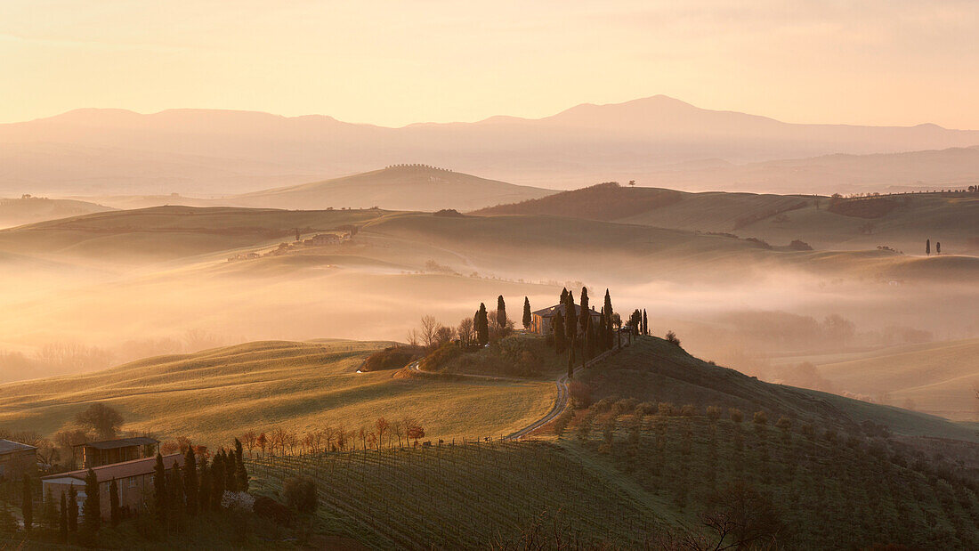 Sonnenaufgang über dem Val d'Orcia in der Nähe von Pienza an einem nebligen Morgen im Frühjahr, Pienza , Toskana, Italien