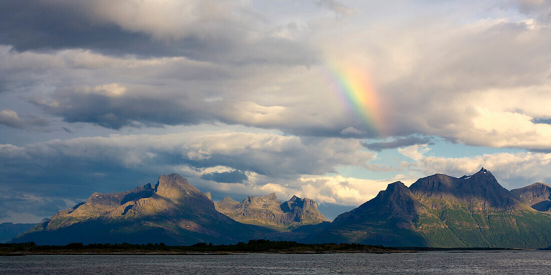 Mountain landscape in northern Norway with rainbow in the evening light, Nordland, Norway