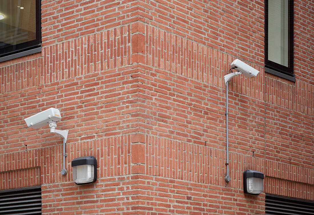 Camera surveillance attached to a red brick wall, near St. Paul's Cathedral, City of London, England, United Kingdom, Europe