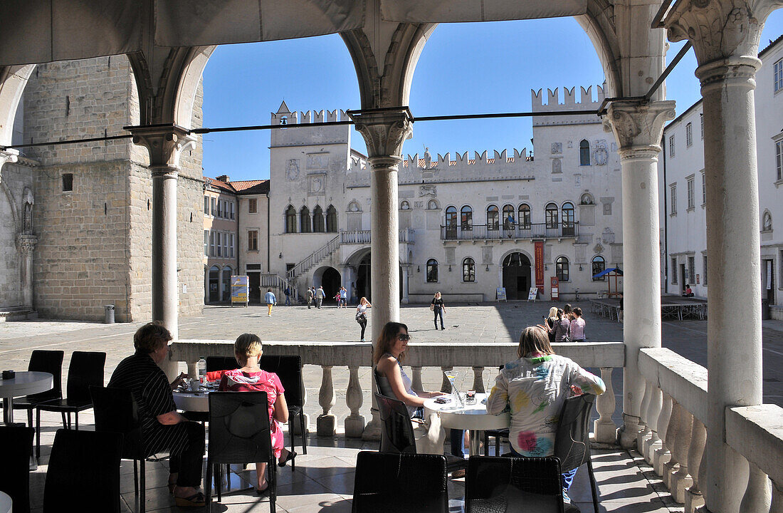 Cafe on Tito square in Koper, Praetorian Palace in the background, Slovenia