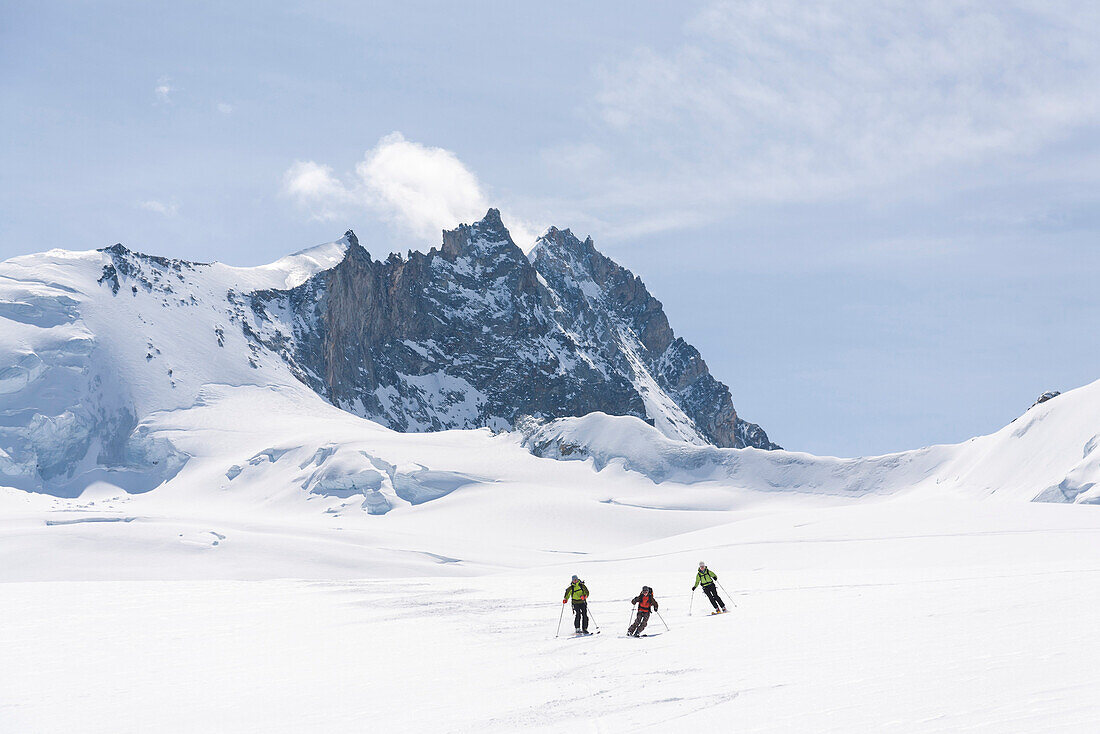 Three skier downhill skiing from Mount Bishorn, Turtmann valley, Canton of Valais, Switzerland