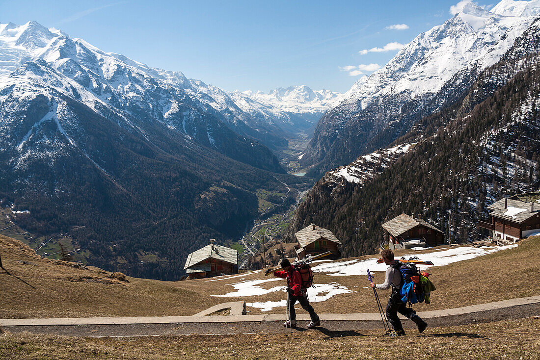 Two skiers arriving Alp Jungen, St. Niklaus, Mattertal, Canton of Valais, Switzerland