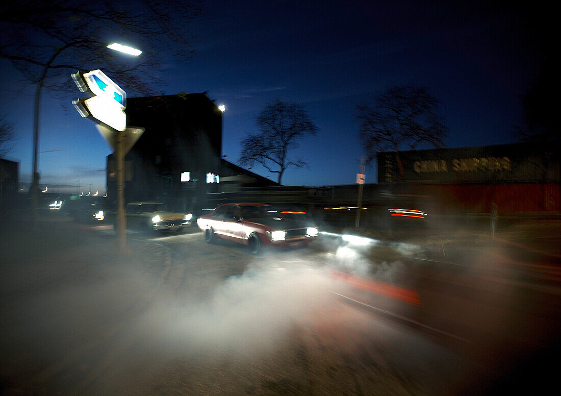 Modern classic cars in harbor area at night, Motoraver group, Hamburg, Germany