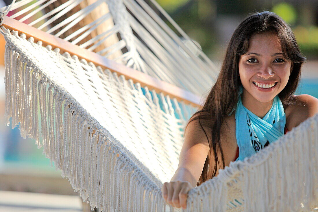 Republic of the Maldives, Lhaviyani Atoll,  Kanuhura Hotel, Portrait of a woman in a hammock